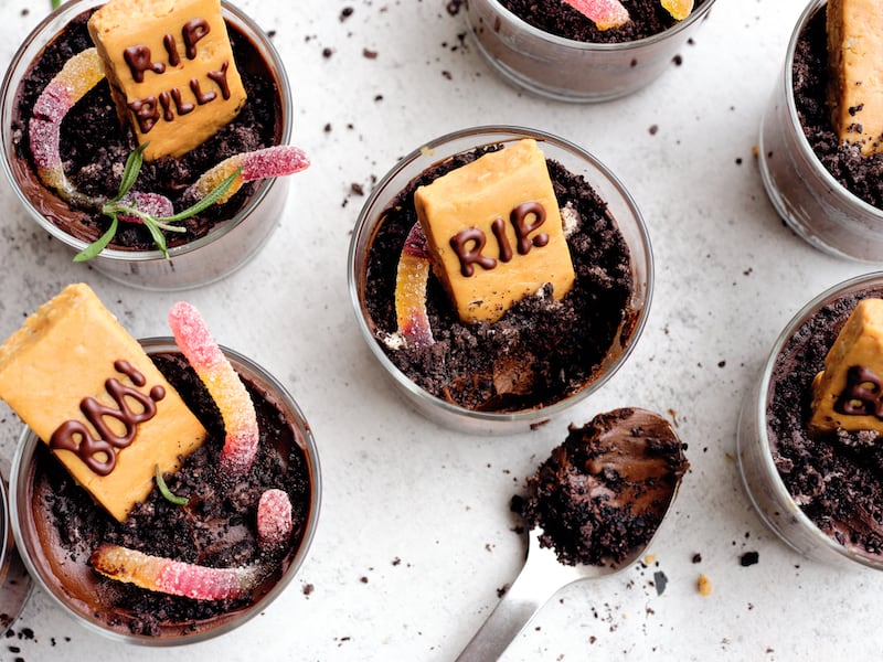 Avocado chocolate mousse dirt cups with candy worms and tombstones